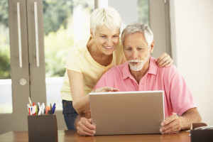 Senior Couple Using Laptop At Home